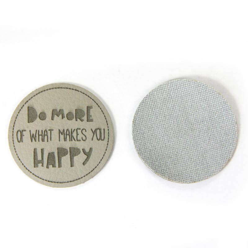 Leather labels, with the inscription "DO MORE OF WHAT MAKES YOU HAPPY"
